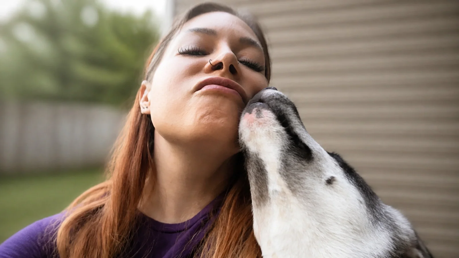 Raven with a pet, representing trusted local care throughout Louisville and Kentuckiana